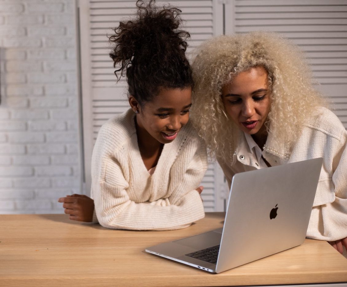 Two women watching laptop screen