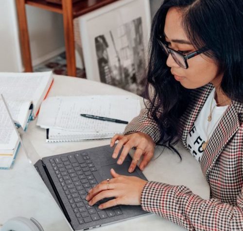 woman conducting research at computer